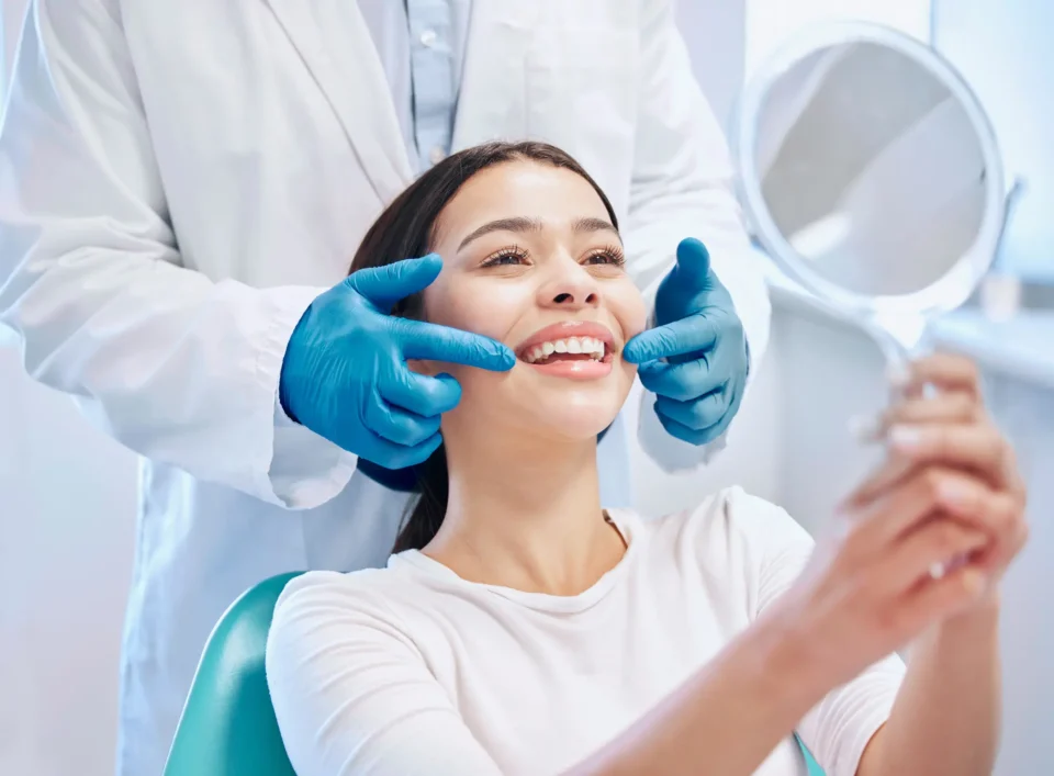 Dentist examining a patient's teeth during a consultation for dental implants in Fenton, MO