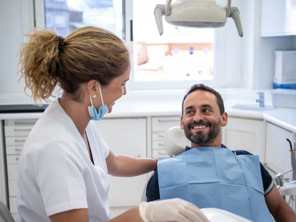 Dentist providing restorative dental care to a patient in a modern clinic in Fenton, MO