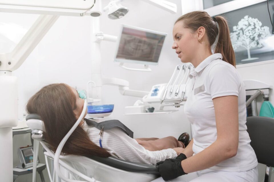 Dentist Providing Sedation Dentistry Treatment to a Patient in a Modern Dental Clinic in Fenton, MO